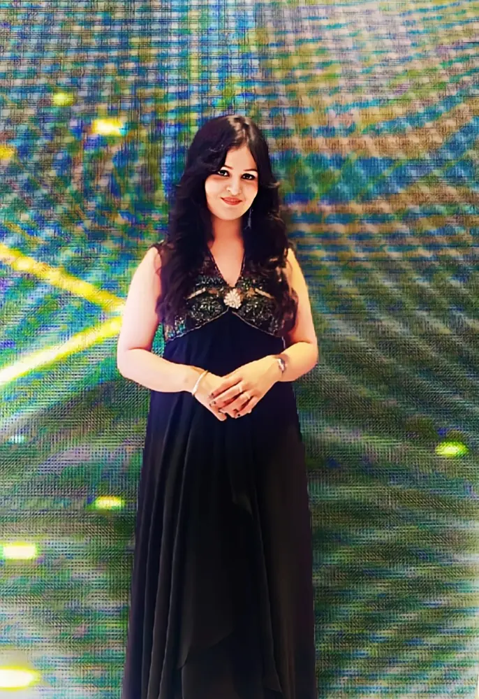 Anupriya Tripathi in a black gown on stage