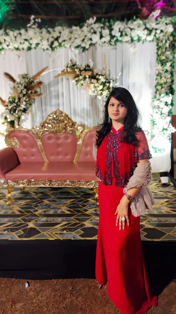 Anupriya Tripathi in a red gown on a decorated wedding stage