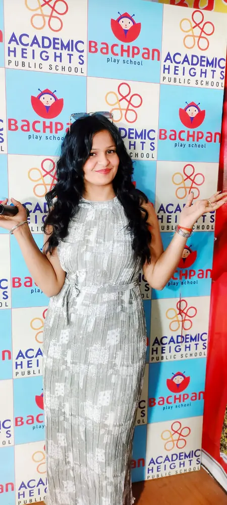 Anupriya Tripathi hosting a school function with a microphone